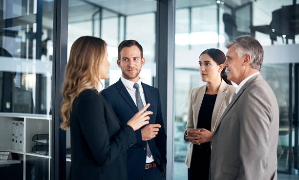 Cropped shot of a group of businesspeople talking in the boardroom after a meeting